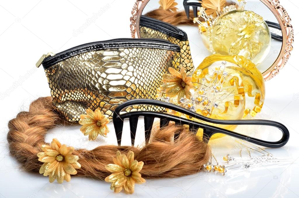 Artificial hair and accessories for women hairstyles, cosmetic bag mirror and comb in still life