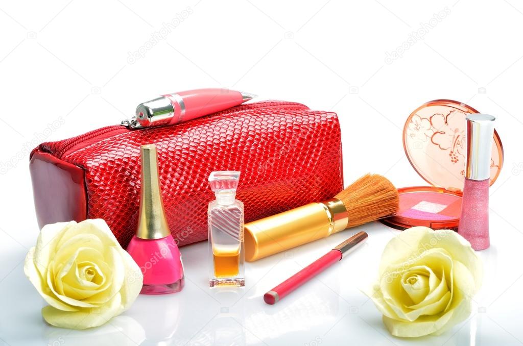 Cosmetic bag, makeup items, perfume and flowers in still life