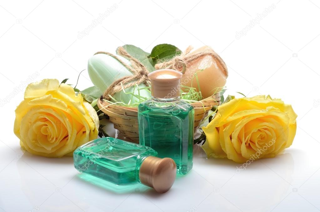 Mini set for spa, sauna bath - small bottles of shampoo, soap and flowers in still life