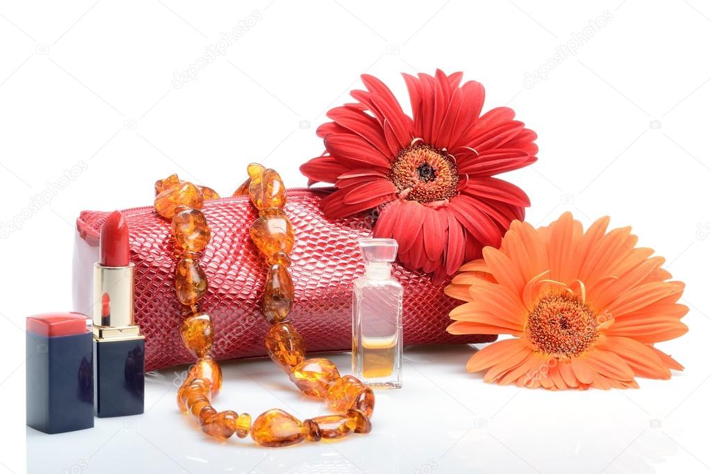 Gerbera flowers, cosmetics, perfumery and cosmetic bag female beads in still life