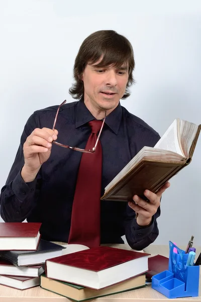 Male school teacher with books, textbooks glasses in hands — Stock Photo, Image