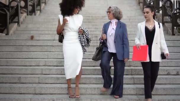 Vrouwelijke uitvoerende werknemers lopen de trap af in hun pak — Stockvideo