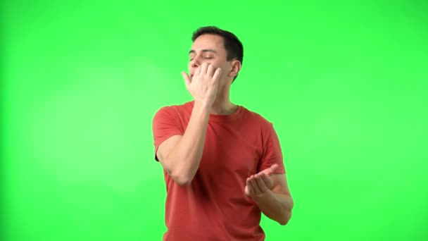 Content man applying moisturizing facial cream against chromakey — Stock Video