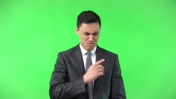 Young embarrassed businessman looking away thoughtfully in studio — Stock Video