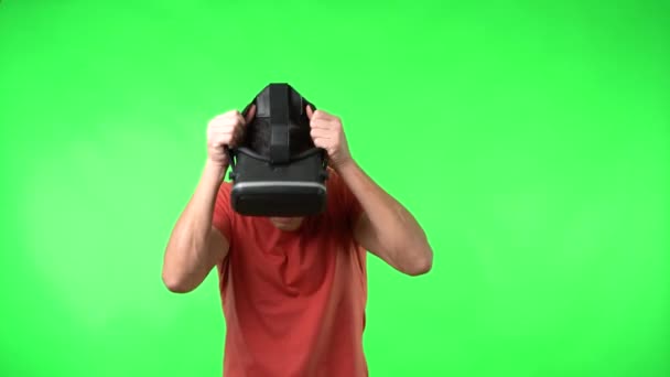 Fearful male in VR goggles exploring virtual reality — ストック動画