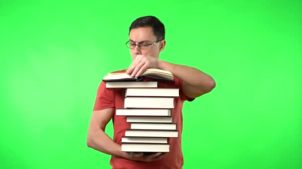 Clever man holding many books and reading with interest — Stock Video