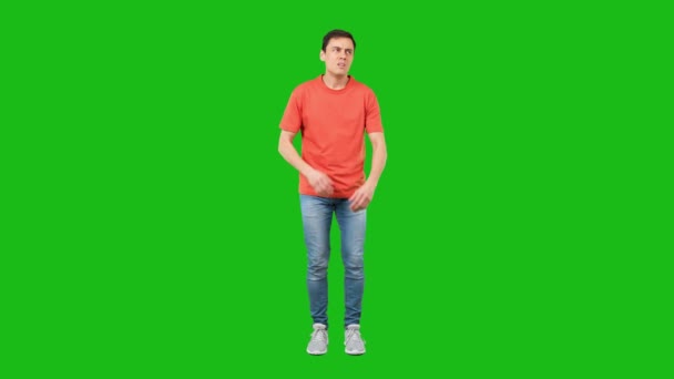 Bored male with crossed arms against green background — Stock Video