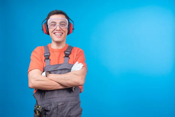 Cheerful carpenter with protective accessories laughing at joke — Stock Photo, Image