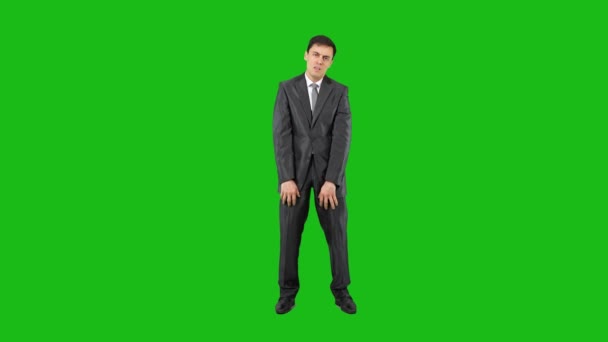 Bored elegant businessman with folded arms looking at camera — Stockvideo