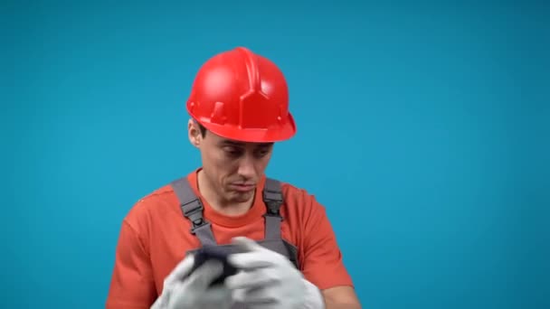 Man i byggare uniform talar på smartphone — Stockvideo