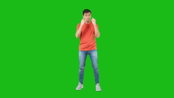 Self assured male making money gesture. Green background — Vídeos de Stock