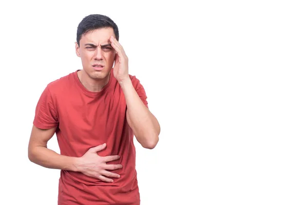 Sick guy touching forehead and stomach in studio — Foto Stock
