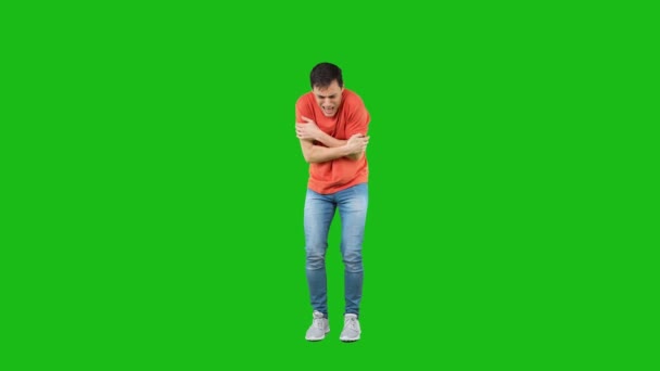 Shivering man standing in studio with crossed arms — Stockvideo