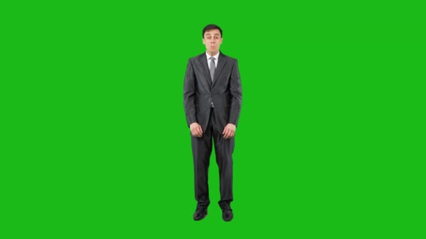 Surprised male employee looking at camera in chroma key — Stock video