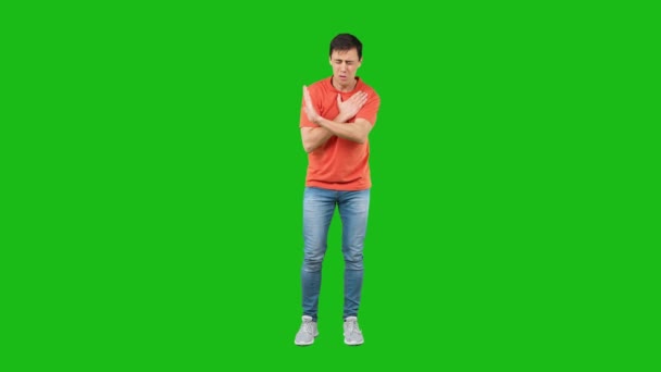 Upset man touching heart and gesturing stop in green studio — Stockvideo