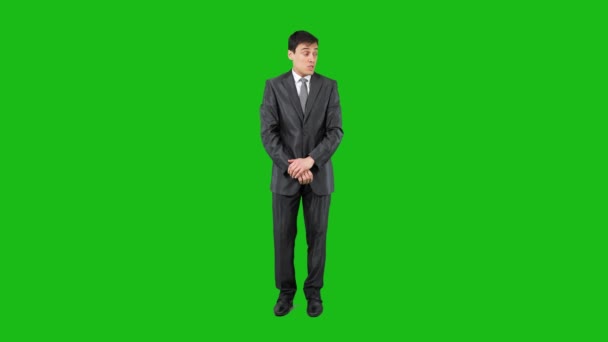 Businessman telling secret in studio. Chroma key — Stockvideo