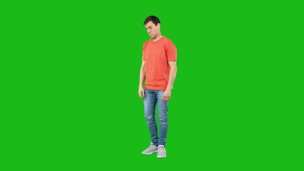 Full Length Man Jeans Orange Shirt Tilting Back Looking Camera — Stock Video