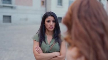 Two caucasian women having an argument in the street
