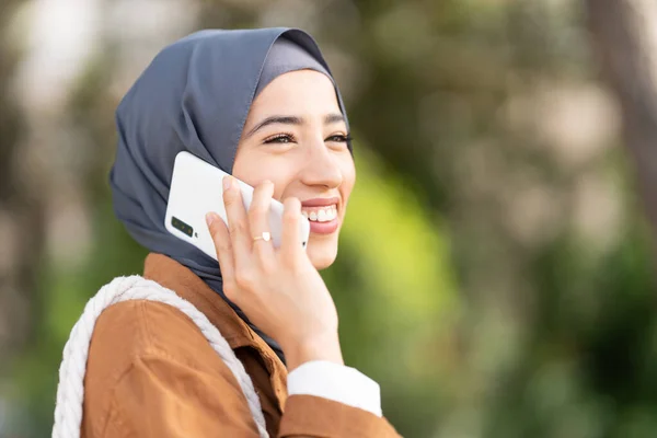 Distracted Smiling Muslim Beauty Woman Talking Mobile Park — Stockfoto