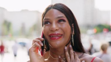Transgender woman smiling while talking to the mobile
