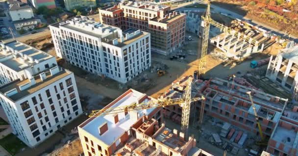 Panoramic view with high-rise crane under construction against buildings — Stock Video