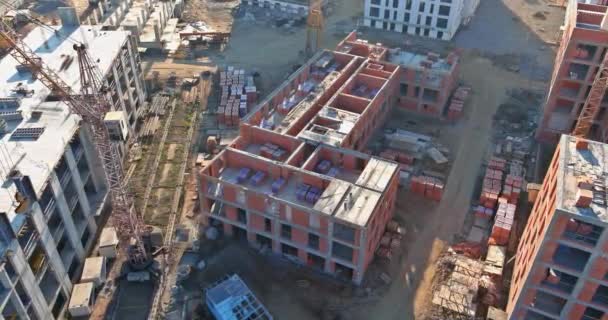 Aerial view with high rise building under construction at tower cranes — Stock Video