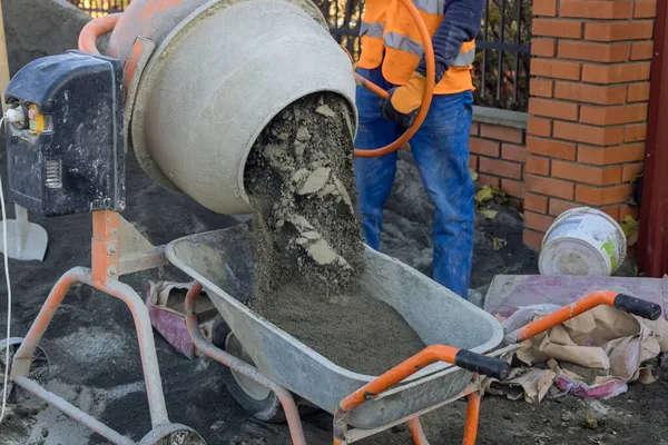 Mixing a sandy base for setting paving stones with preparation installation in progress stone bricks