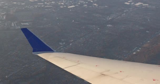 Airplane wing view out of the window on the cloudy sky the earth background — Stock Video