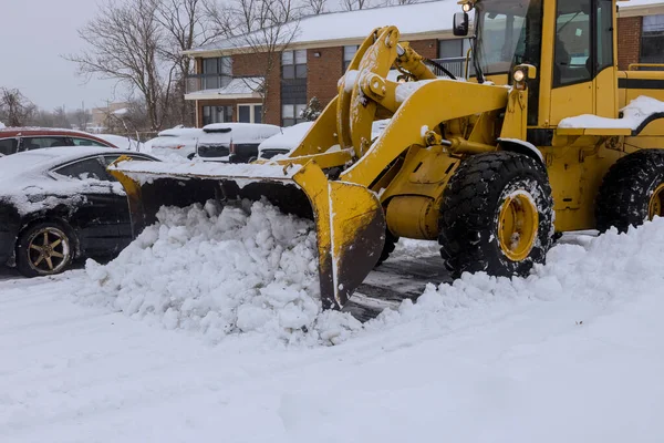 Tractor road maintenance with snow clearing in heavy snowfall