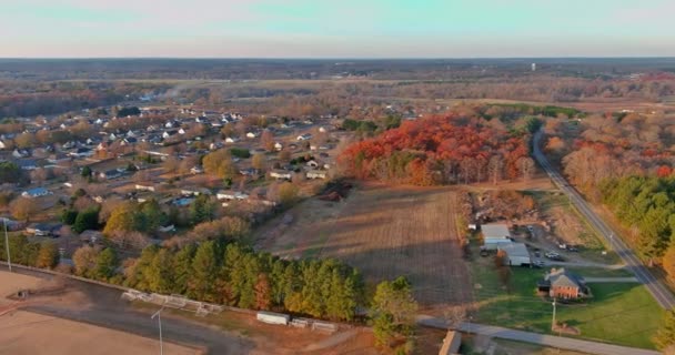 Aerial view of houses by roadside in countryside rural road in Boiling Spring South Carolina with colorful autumn fall trees foliage — 图库视频影像