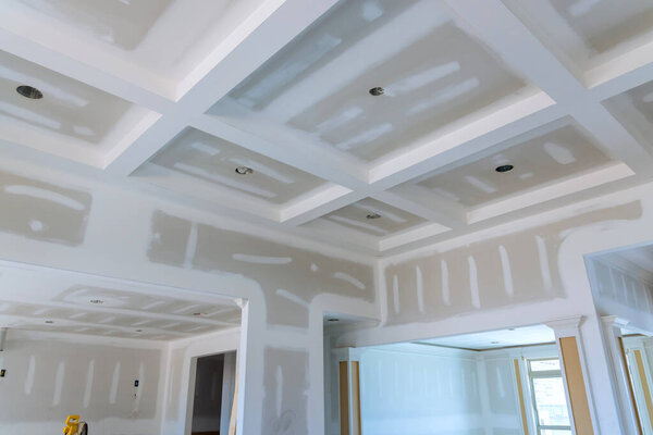 Laid plastering gypsum on the walls and ceiling to drywall seams of ready for paint a newly built house