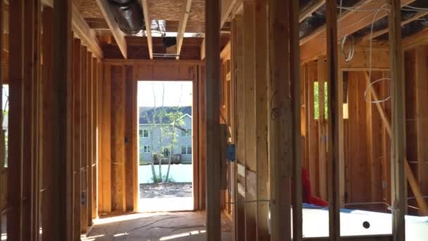 Inside view of wooden under construction new residential apartment beam framing — Stock video