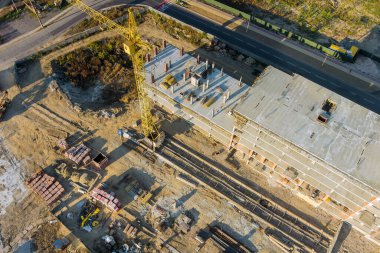 Tower crane on a construction site high-rise building under construction modern residential complex with aerial view