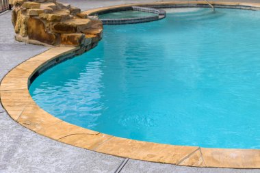 Empty swimming pool in beautiful park with blue water