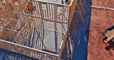 Aerial view of big construction dumpster on stacker wooden material boards and beams for new house on of under construction