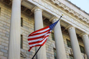 Washington DC building detail with waving American flag in USA