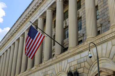 US office building detail with waving American flag in Washington DC United States