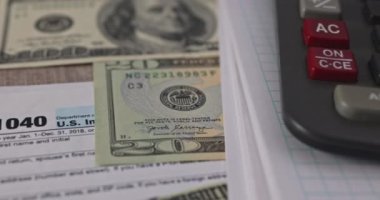 IRS form 1040 with individual income tax return of dollar bills of Stimulus economic tax return check