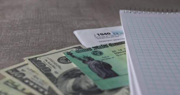 IRS form 1040 with individual income tax return of dollar bills of Stimulus economic tax return check — стокове відео