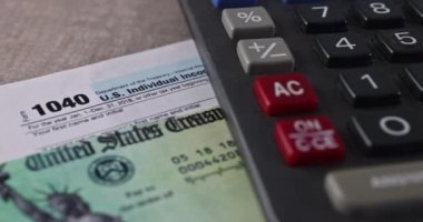 IRS form 1040 with individual income tax return of dollar bills of Stimulus economic tax return check