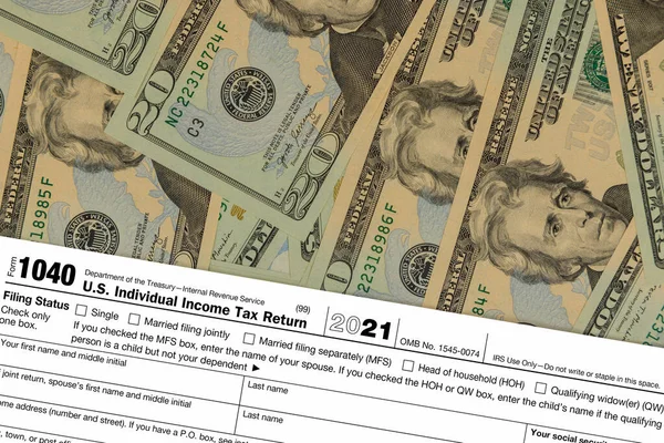 Pay Tax U.S. Individual Income Tax Return form 1040 and USA currency hundred dollar bills