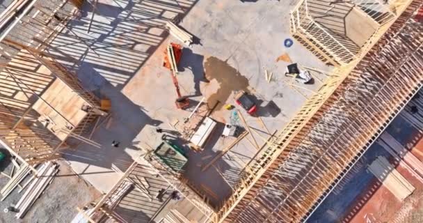 Top aerial view new framing stick built building of beams on new home under construction — Stock Video