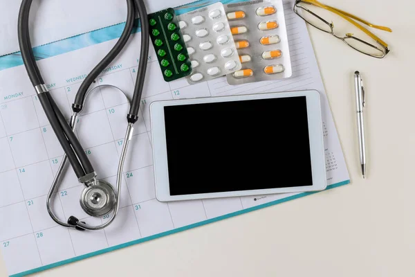 Sağlık Steteskopu Dijital Cihaz Tablosu Çalışma Masasındaki Haplarla Takvimde Doktor — Stok fotoğraf