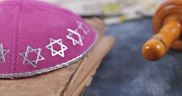 Jewish holidays in a synagogue prayer items with prayer shawl tallit shofar, torah scroll on soft focus — ストック動画