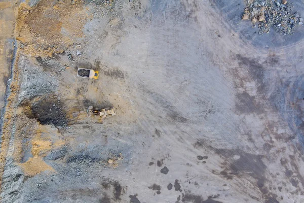 采石场装载花岗岩石的挖掘机空中俯瞰图 — 图库照片