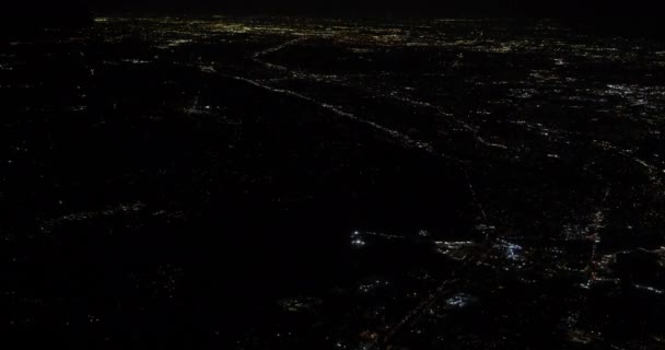Uitzicht vanaf een vliegend vliegtuig uit het raam van de stad 's nachts — Stockvideo