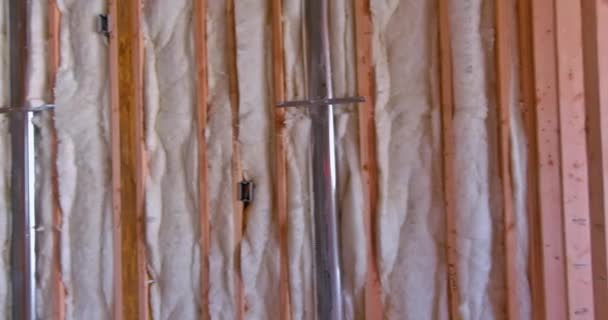 Мінеральна скляна вата в дерев'яній рамі на похилій стіні біля дерев'яної стелі приватний будинок — стокове відео