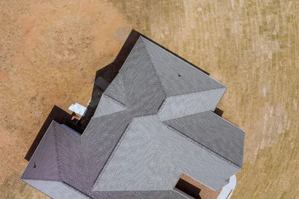 Vista aérea de la construcción en construcción nueva casa de construcción en la azotea cubierta de tejas de asfalto techado —  Fotos de Stock