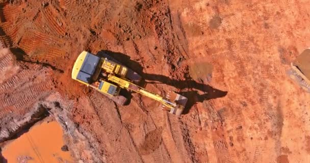Digger on earthworks in excavator dig the trenche at construction site on arial view of earth moving heavy equipment — Stock Video