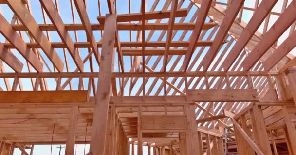 Roof trusses covered with condominium construction installation of wooden beams frame — Stock Video